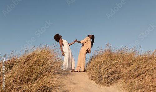 Black couple holding hands in countryside