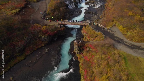 Tourists taking pictures from Brúarfoss waterfall in Iceland. Aerial photo