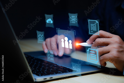 Businessman using laptop data analyzing Management online. Human resource management sheet. Virtual screen technology. Data analysis and Document Management System. web 3.0 and managing corporate.