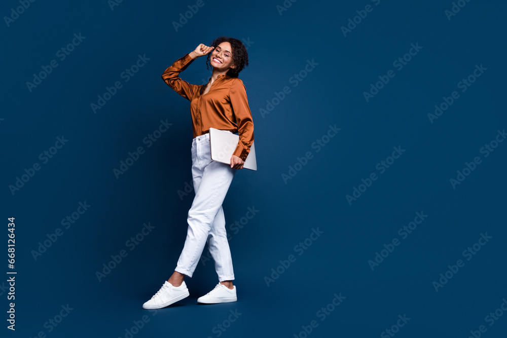 Full size photo of attractive woman walking it professional dressed stylish brown silk formalwear isolated on dark blue color background Full size photo of attractive woman walking it professional dressed stylish brown silk formalwear isolated on dark blue color background