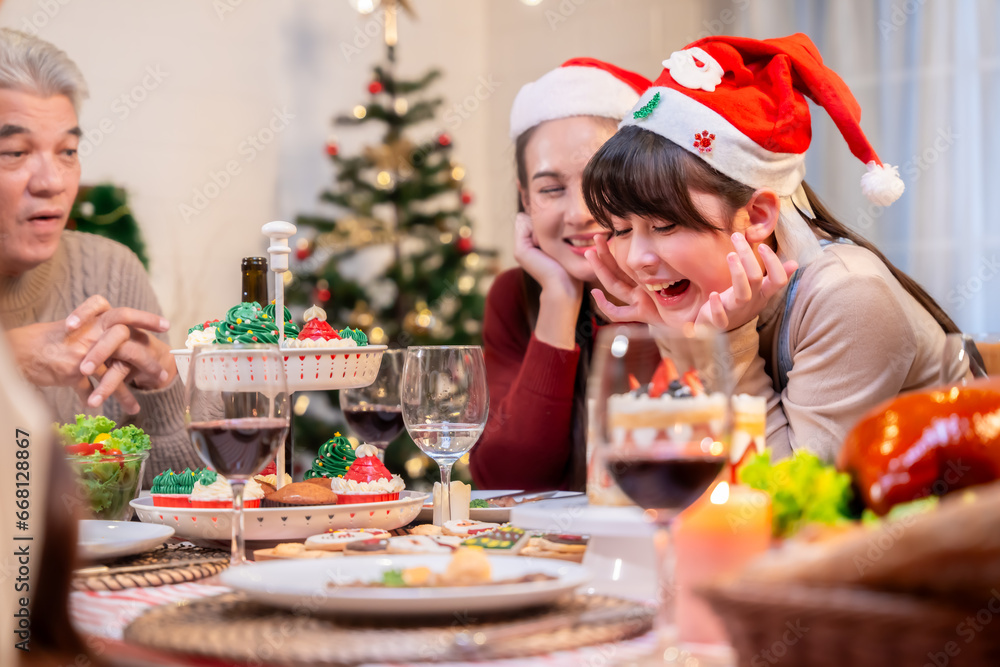 Asian family's Christmas celebration in their home Eating together at the dining table Asian family's Christmas celebration in their home Eating together at the dining table