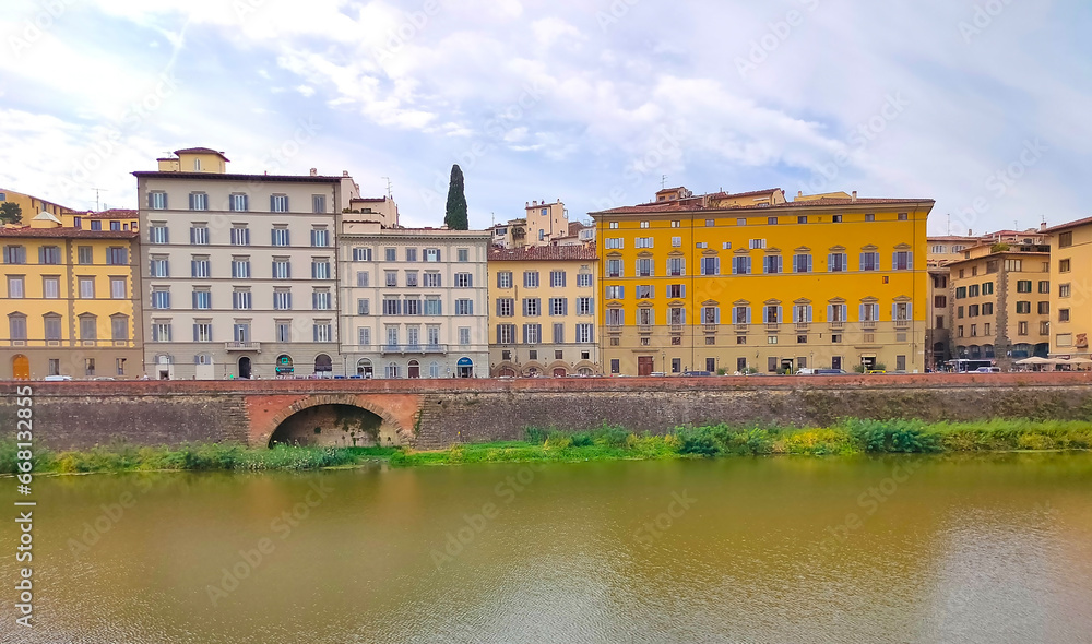 Naklejka premium Colorful historic streets of Florence, Italy. Narrow old street, building's facade, brick walls.