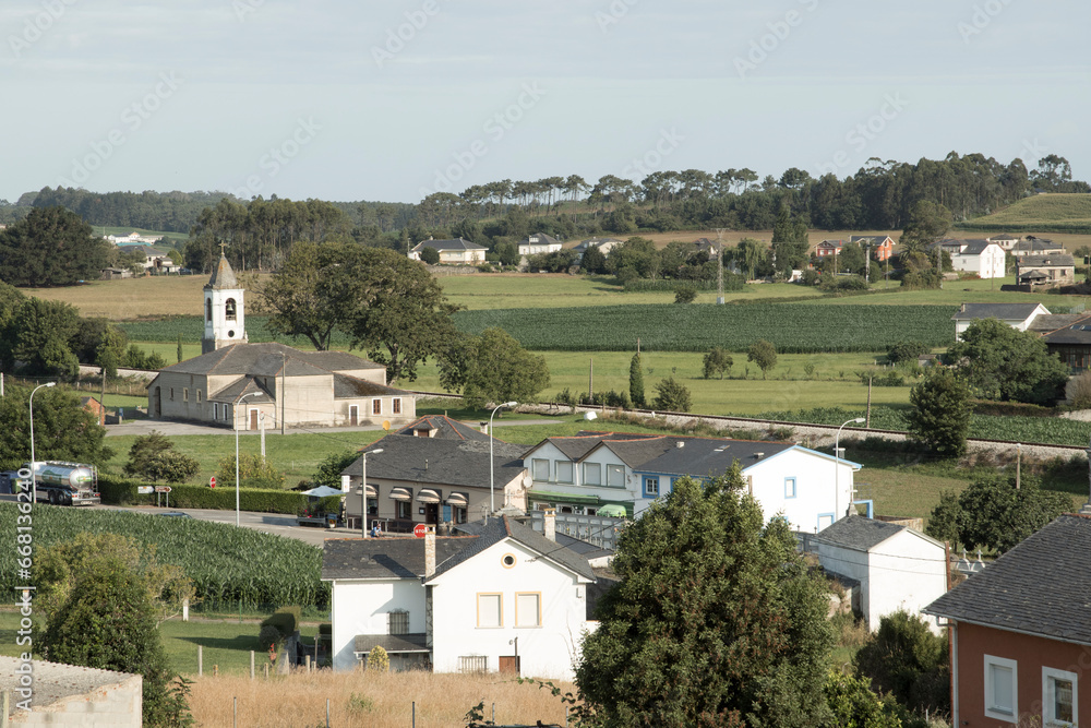 A Serene Snapshot: Small Town Nestled Amidst Verdant Farmland and Majestic Church