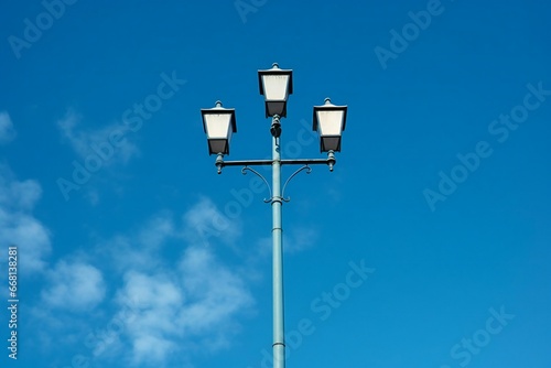 Lamppost on blue sky background with white clouds,  Street lamp