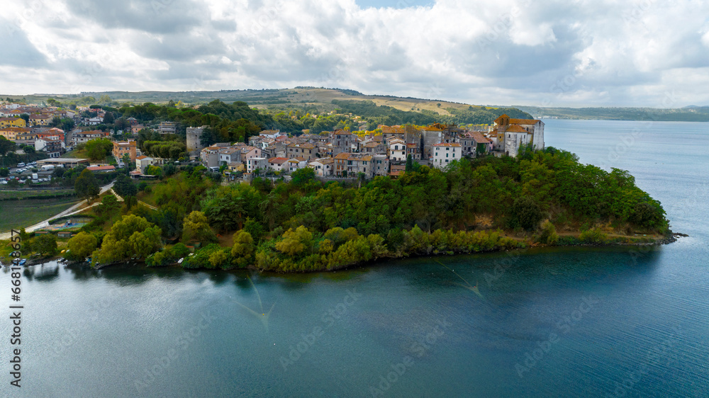 Fototapeta premium Aerial view of the historic center of Anguillara, in the metropolitan city of Rome, Italy. The town is located on the shores of Lake Bracciano.