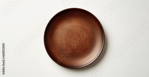 Empty ceramic plate lying on a table. Flat lay, top view