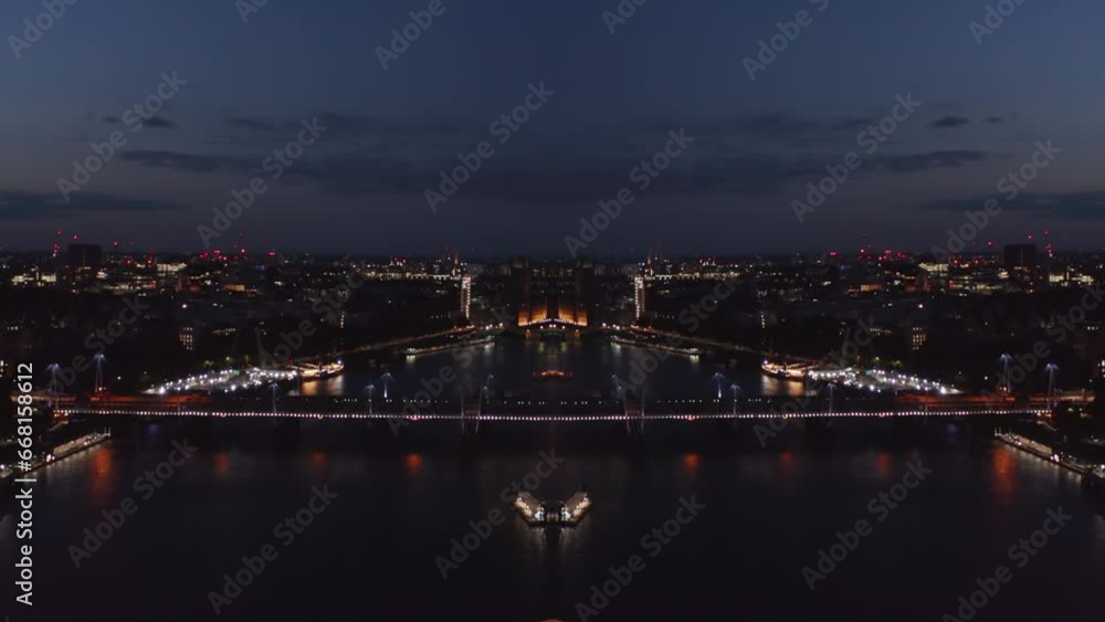 Aerial view of night London. City and illuminated bridge over river. Abstract computer effect digital composed footage Aerial view of night London. City and illuminated bridge over river. Abstract computer effect digital composed footage