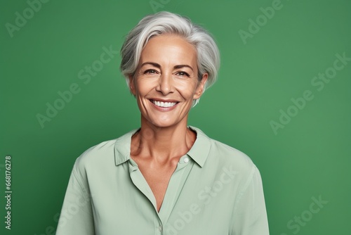 Sophisticated Woman in Green Blouse Against Monochrome Background