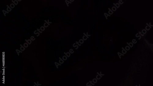 the girl lying on the bed inside the cabin turns off the light on the bedside table.
