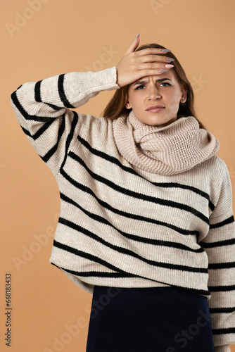 фотографія Young woman in wool sweater suffering from headache