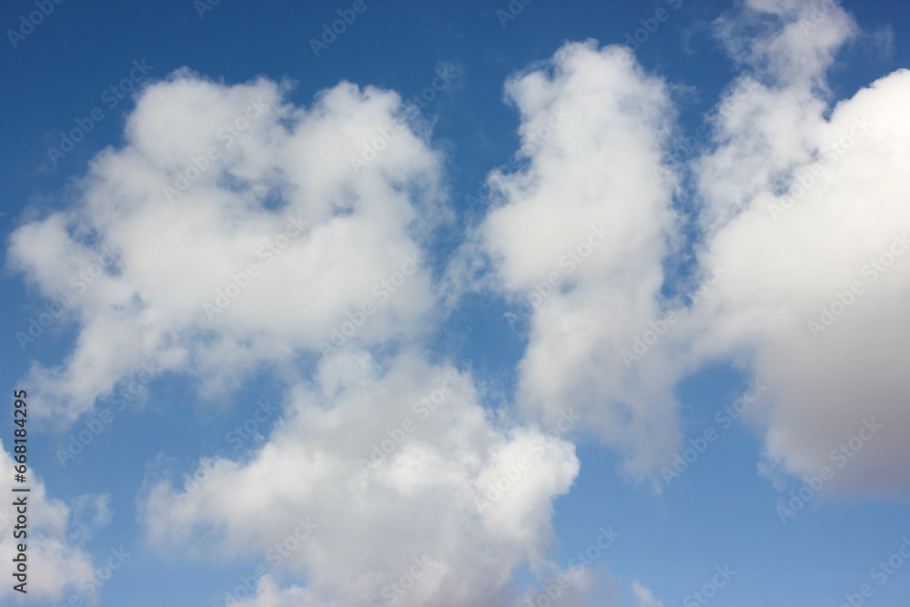 A clear blue sky with soft, billowing layers of white clouds is a symbol of good weather A clear blue sky with soft, billowing layers of white clouds is a symbol of good weather