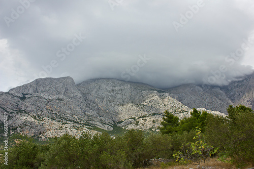 Mountain scenery. High mountains with peaks covered by clouds