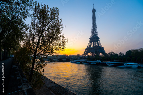Eiffel Tower, French: Tour Eiffel, silhouette at sunrise time on sunny day. View from Seine River. Paris, France © pyty