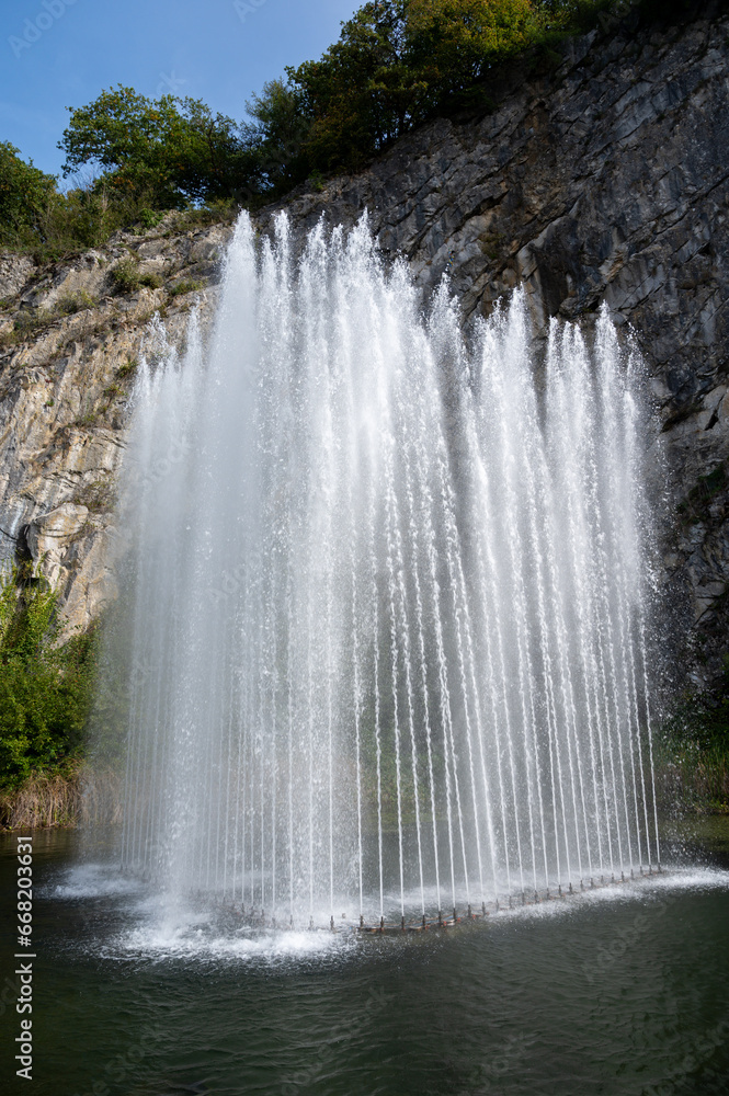 Big fontain by rock, walking in smallest medieval town in world Durbuy on river Ourthe, Ardennen, Belgium