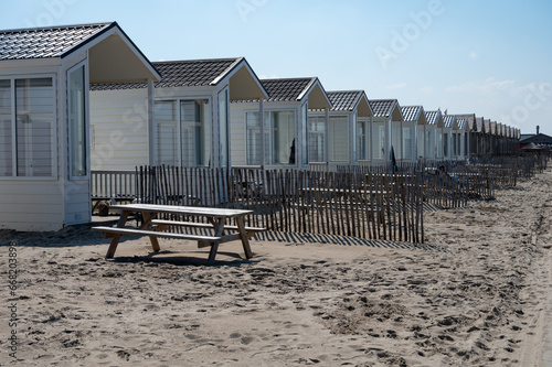 Beach holidays on sandy beach, waterfront wooden cottages in Katwijk-on-zee, North sea, Netherlands photo