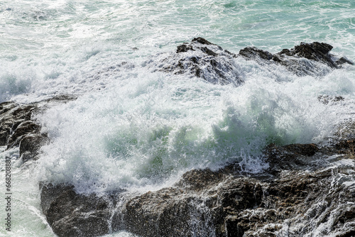 Large waves crush the coastline near Porto Covo, Portugal photo