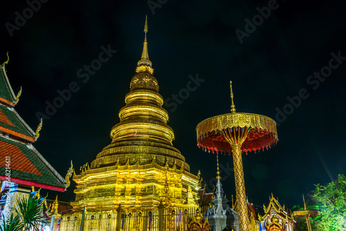 Beautiful of Night,evening the golden pagoda at Wat Phra That Hariphunchai is a Buddhist worship temple It is a major tourist attraction In the city of Lamphun Thailand.