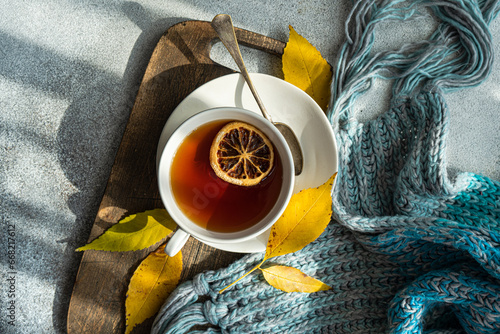 Overhead view of a cup of spiced black tea with lemon and autumnal styling photo