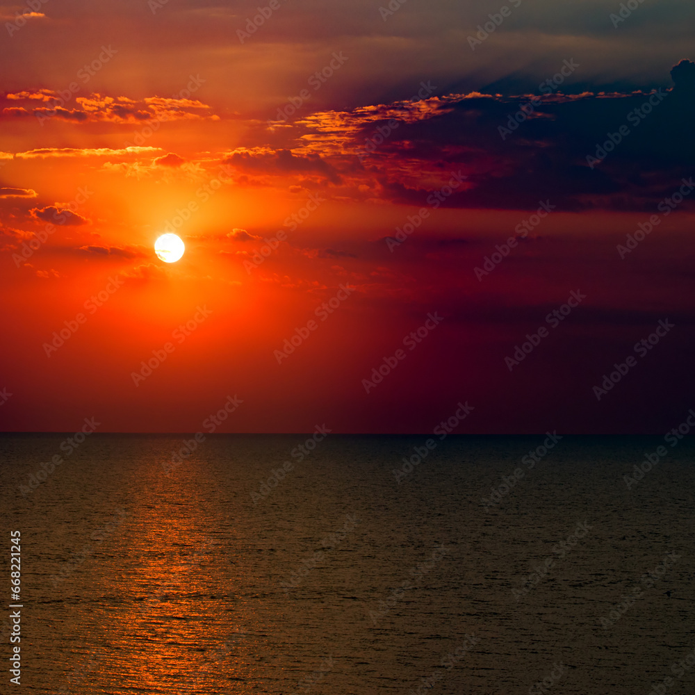 Beach of the sea and red sunise. Bright background.