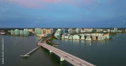 John Ringling Causeway leading from downtown to St. Armands Key in Sarasota city, Florida. Waterfront office high-rise buildings and car traffic on bridge photo