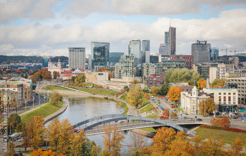 Obraz premium Vilnius, capital of Lithuania, Europe. Aerial view of the city, modern business financial district, modern architecture, buildings and skyscrapers, with Neris river and bridge in autumn