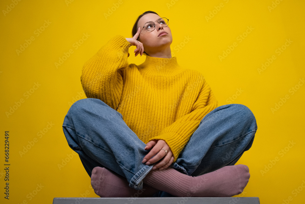 Portrait of creative woman arm touch chin look empty space brainstorming isolated on yellow background Portrait of creative woman arm touch chin look empty space brainstorming isolated on yellow background