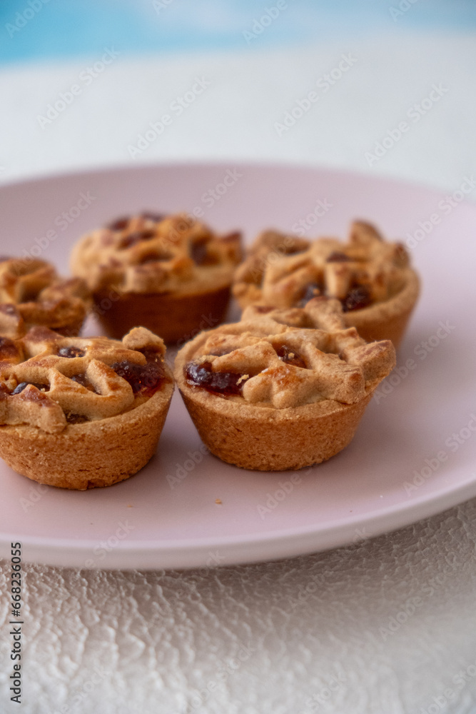 Apple pie on a pink plate on a white background Apple pie on a pink plate on a white background