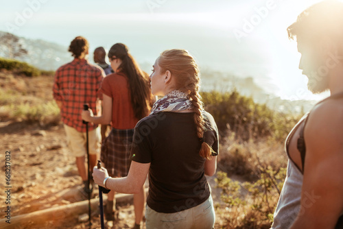 Enthusiastic friends navigate a forest trail during their hiking adventure photo