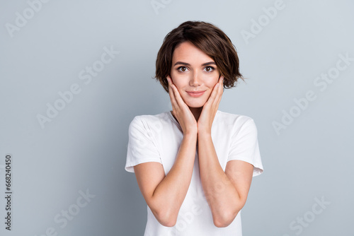 Photo of sweet shiny lady wear white t-shirt arms cheeks empty space isolated grey color background