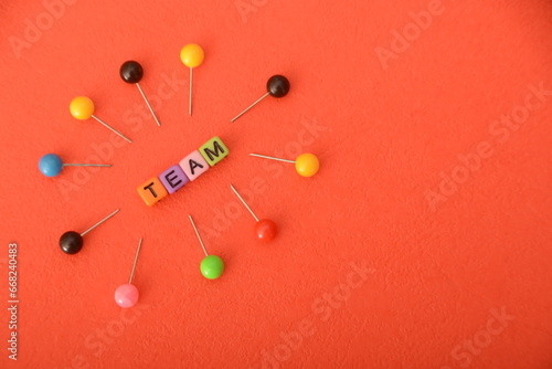 Alphabet beads with text TEAM. In a business context, a team refers to a group of individuals working collaboratively and cooperatively toward a common goal or objective.