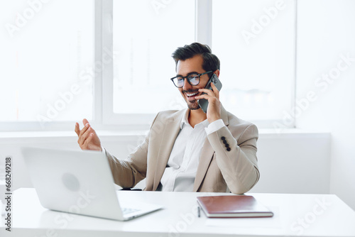 Winner man businessman phone talk computer laptop document office smile successful