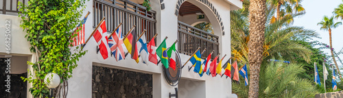 Flags of the Europeans countries in front of a Hotel building in Cape Verde photo