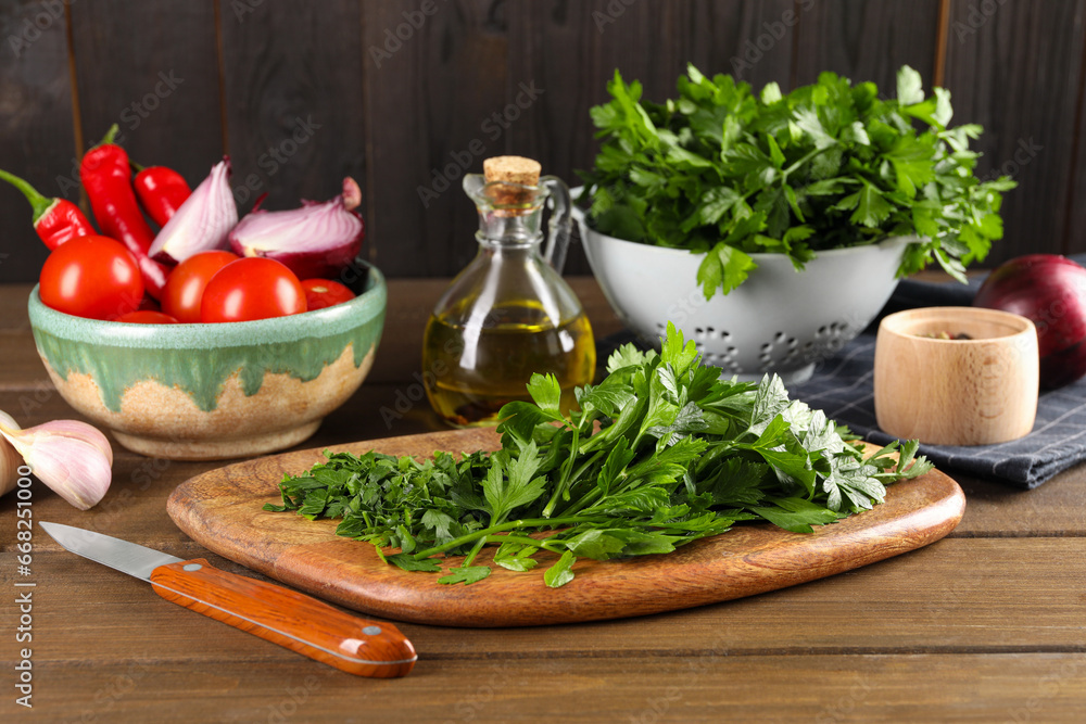 Fresh green parsley and different products on wooden table Fresh green parsley and different products on wooden table