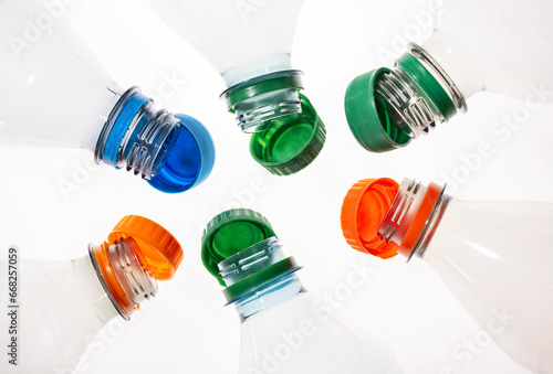 Plastic bottles with tethered caps in different colors photo