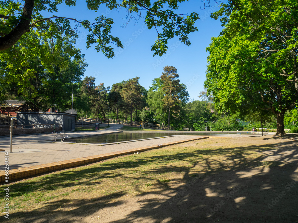 Empty childrens pond in park in summer with blue sky Empty childrens pond in park in summer with blue sky