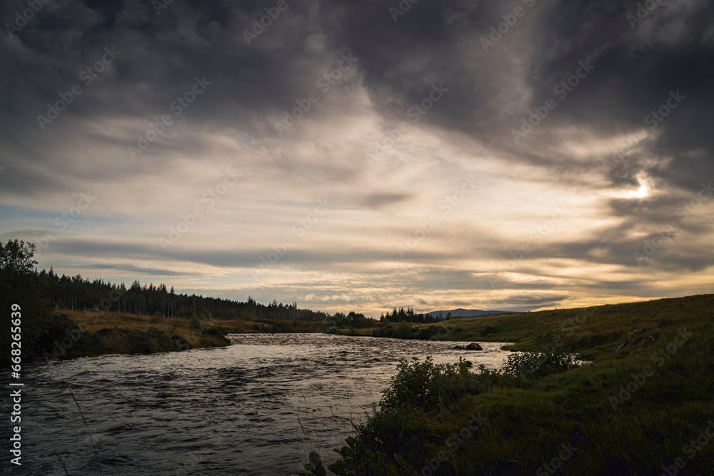 An autumnal dusk HDR image of the River Naver, known as a salmon river, and the Naver Forest in Strathnaver, Sutherland, Scotland