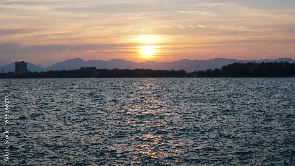 Calm sea with sunset sky and sun through the clouds over. Meditation ocean and sky background. Tranquil seascape. Horizon over the water.