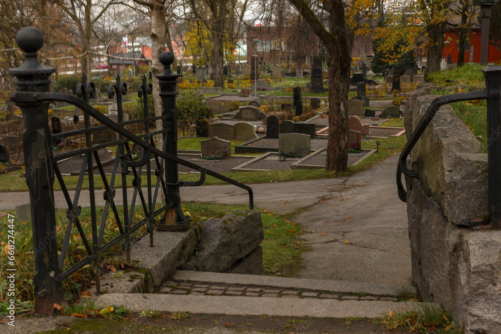 Stairs leading to a well-kept cemetery on an autumn day