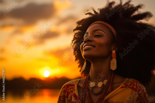 Radiant Afrocentric Woman Amidst a Serene Savannah Dusk