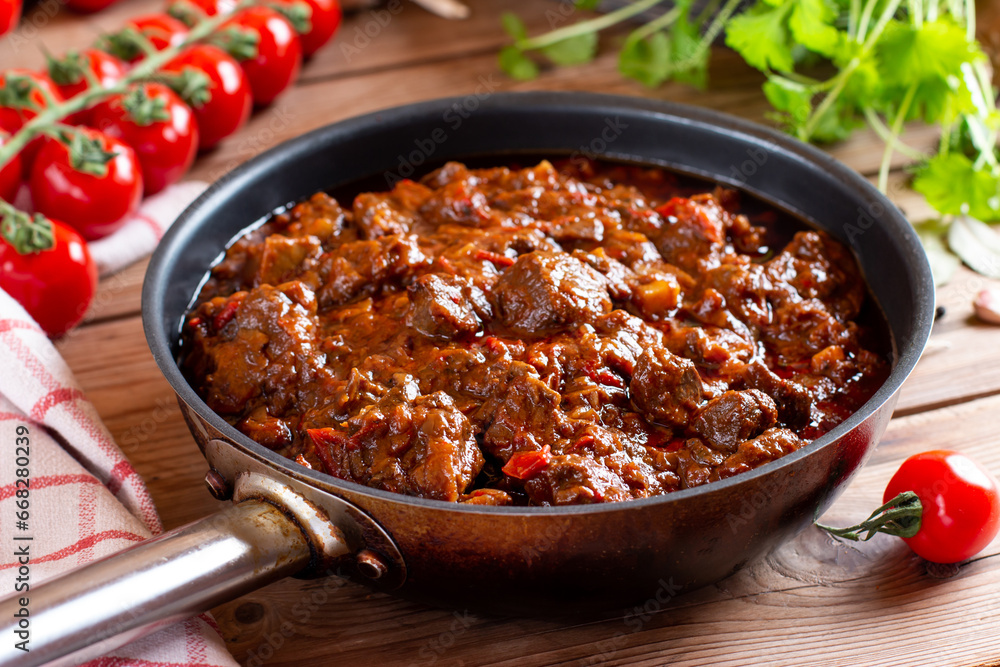Tasty Hungarian goulash soup bograch close-up on a table and ingredients. Horizontal Tasty Hungarian goulash soup bograch close-up on a table and ingredients. Horizontal