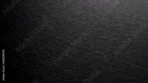 Close-up of BLACK textured CARDBOARD sheet, ideal as a clean background for creative projects or presentations.