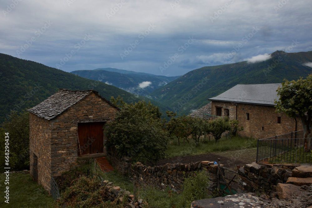 Rural landscape with stone houses in a stormy day. Asin de Broto, Huesca, Spain