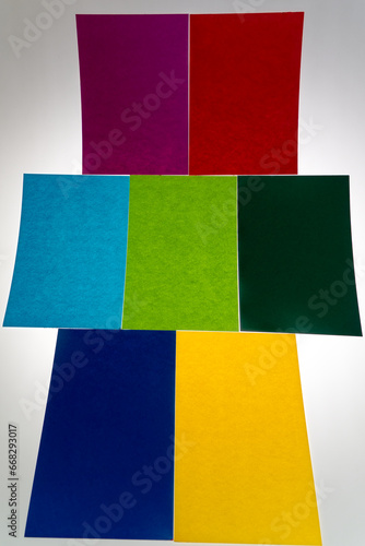 Abstract arrangement of blank papers in different colors against white background. Photo taken October 26th, 2023, Zurich, Switzerland.