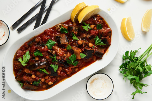 Maghmour or Lebanese moussaka. Dish made from baked or fried eggplant with spices, chickpeas and tomato sauce. Eggplants are stewed in tomato sauce