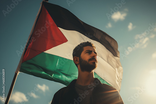 A Palestinian man holds a flag at a rally photo