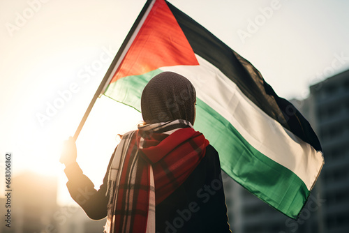 An Arab woman holds a Palestinian flag at a demonstration photo