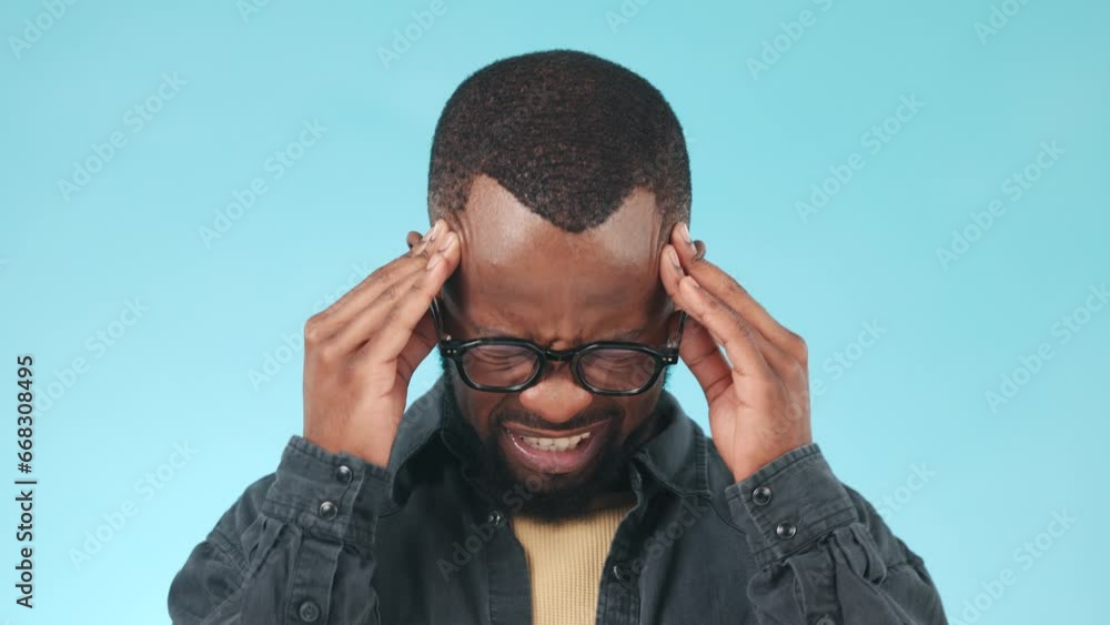 Black man, headache and pain, massage temple with stress or burnout in studio on blue background. Migraine, tension and brain fog with mockup space, hurt and life crisis with vertigo and fatigue Black man, headache and pain, massage temple with stress or burnout in studio on blue background. Migraine, tension and brain fog with mockup space, hurt and life crisis with vertigo and fatigue