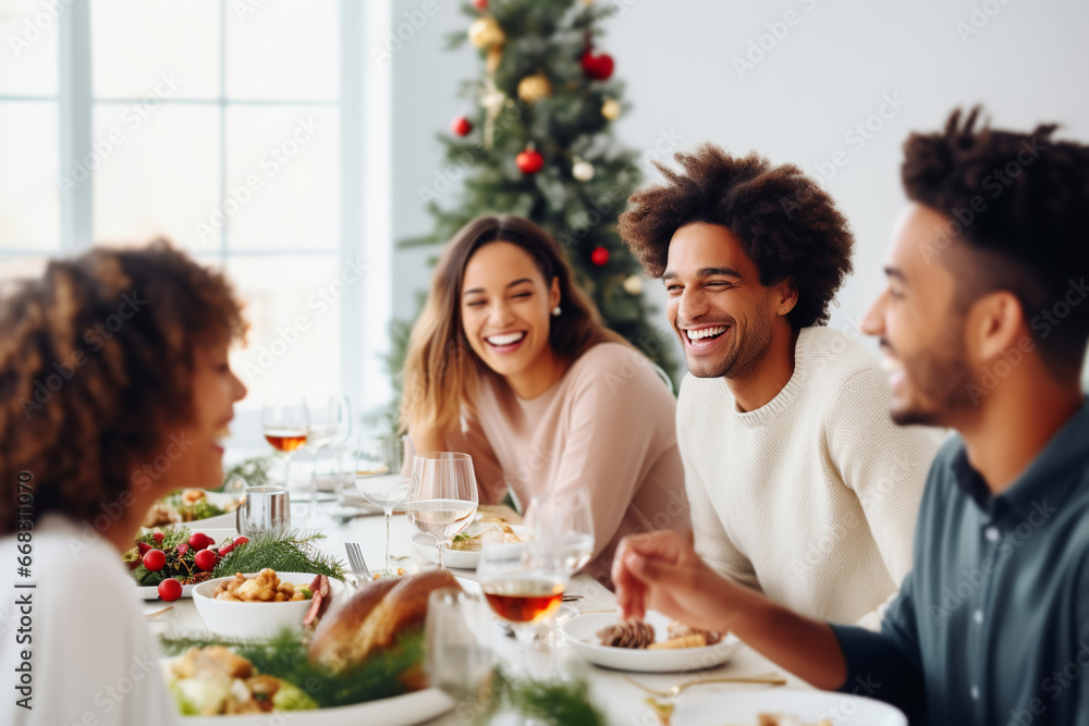 Multiracial friends having christmas dinner and eating together in a cozy minimal room