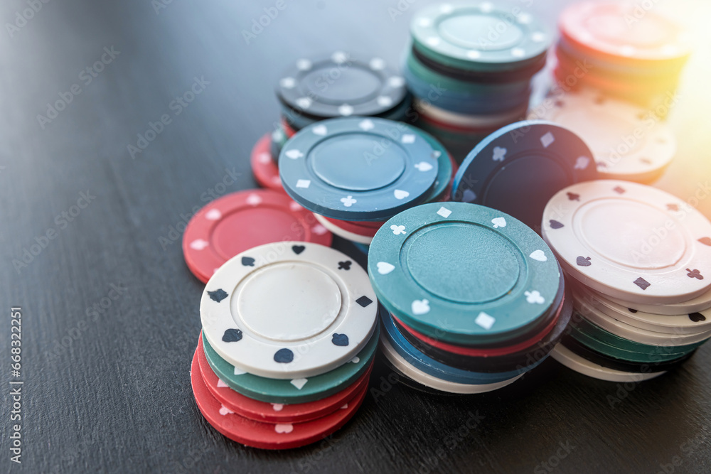 Stacks of poker chips on the black casino table Stacks of poker chips on the black casino table