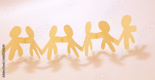 Paper chain team holding hands united